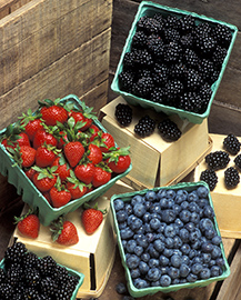 Containers of strawberries, blackberries and blueberries.