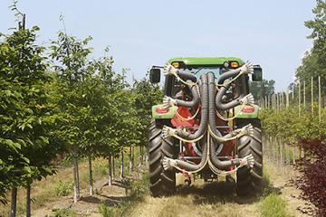 Sprayer machine in apple orchard