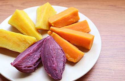 Slices of purple, orange and yellow-fleshed sweet potatoes