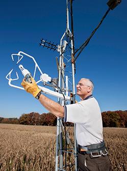 Hydrologist Bill Kustas checks the position of a sensor on a micrometeorological tower.