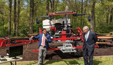 ARS research ecologist Steven Mirsky and USDA Secretary Tom Vilsack with a Deep Soil Core Rig tractor.