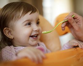 A baby being spoon fed