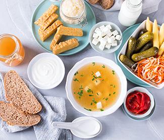 Foods containing probiotics including tempeh, kombucha, sauerkraut, pickles, kefir, yogurt, miso soup, soft cheese, sourdough bread