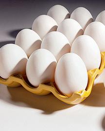 An open carton holding a dozen eggs. 