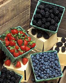 Containers of strawberries, blackberries and blueberries.