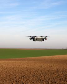A drone hovering over a field