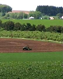 A tractor plowing a field. 