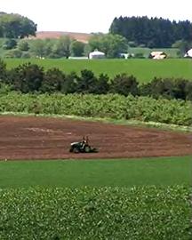 Regenfarmint A tractor plowing a field.
