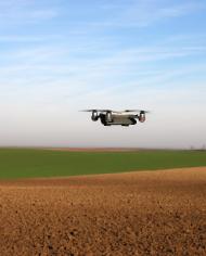 A drone hovering over a field