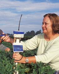 Technician in a field working with telemetry equipment used to validate Irrigator Pro recommendations.
