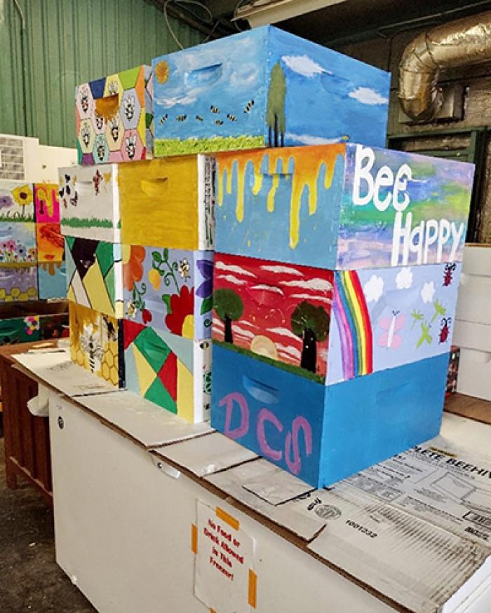 A stack of decorated bee boxes