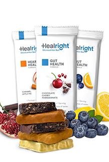 Healthbars Three "Heal Right" micronutrient bars in their wrappers and surrounded by blocks of chocolate, blueberries and raspsberries