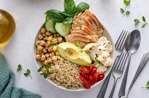 Healthy high protein lunch bowl with grilled chicken, roasted cauliflower, herbed chickpeas and quinoa. (Getty Images). 